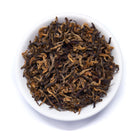 Single estate Nepalese black tea from August Uncommon Tea, featuring rare gold leaves in a 60g tin.