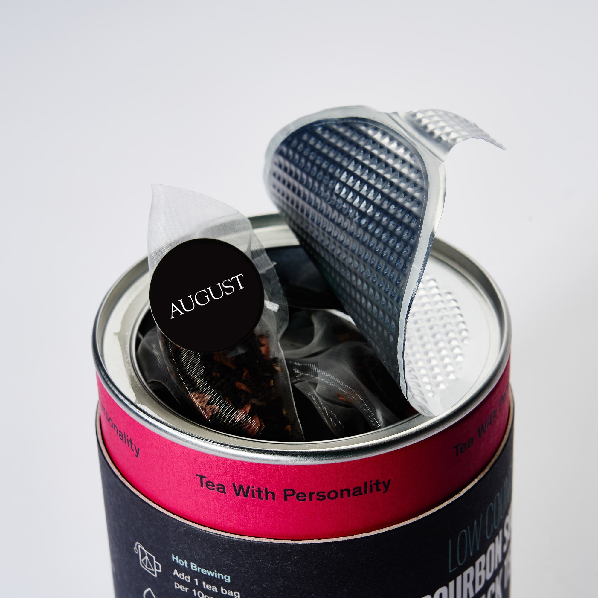 Low Country black tea bags by August Uncommon Tea, 15-pack, shown in a box with individual tea bags and branding.