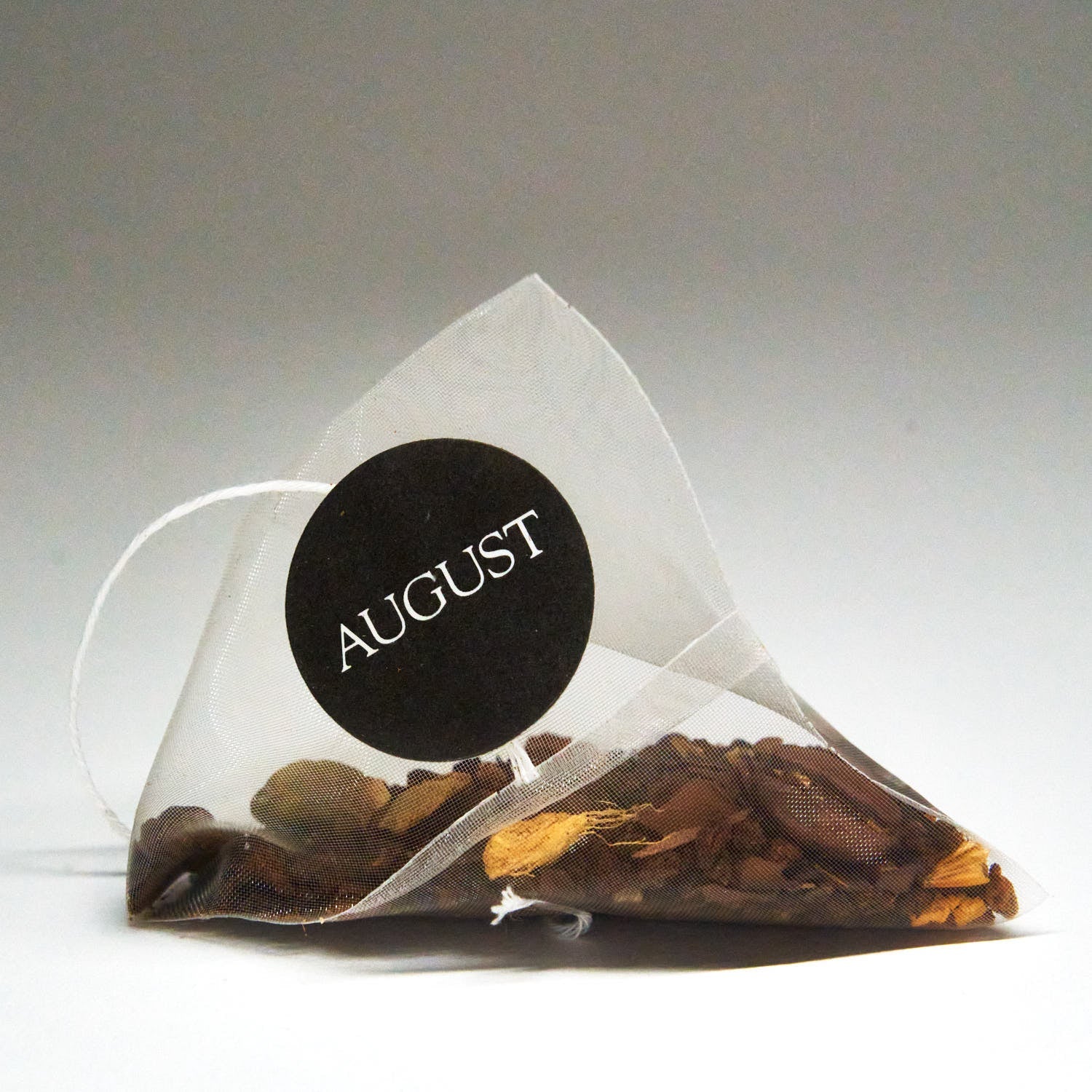 Box of August Uncommon Tea Dirty Chai with spicy black tea and coffee, featuring 15 tea bags in a colorful packaging.