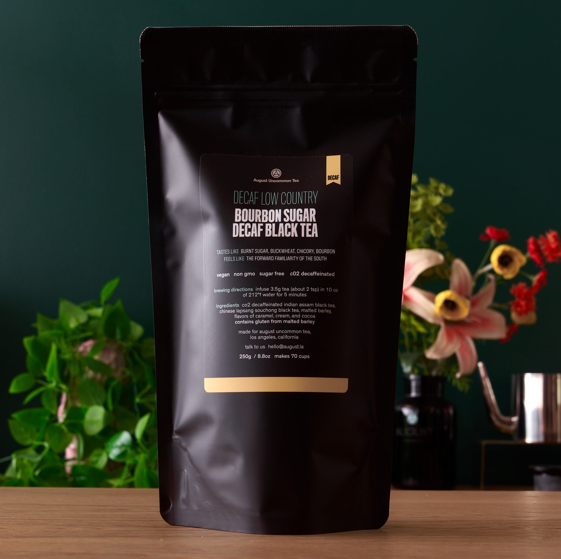 Decaf Low Country Bourbon Sugar Black Tea by August Uncommon Tea in a 15-cup bag, showcasing dark brewed tea with a rich aroma.