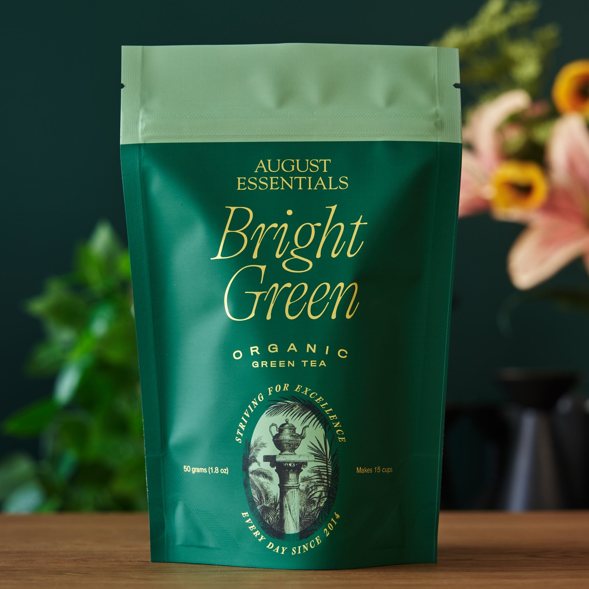 Bright green August Uncommon Tea Essentials Bright Green Green Tea bag, loose tea leaves in a clear tea bag for brewing.