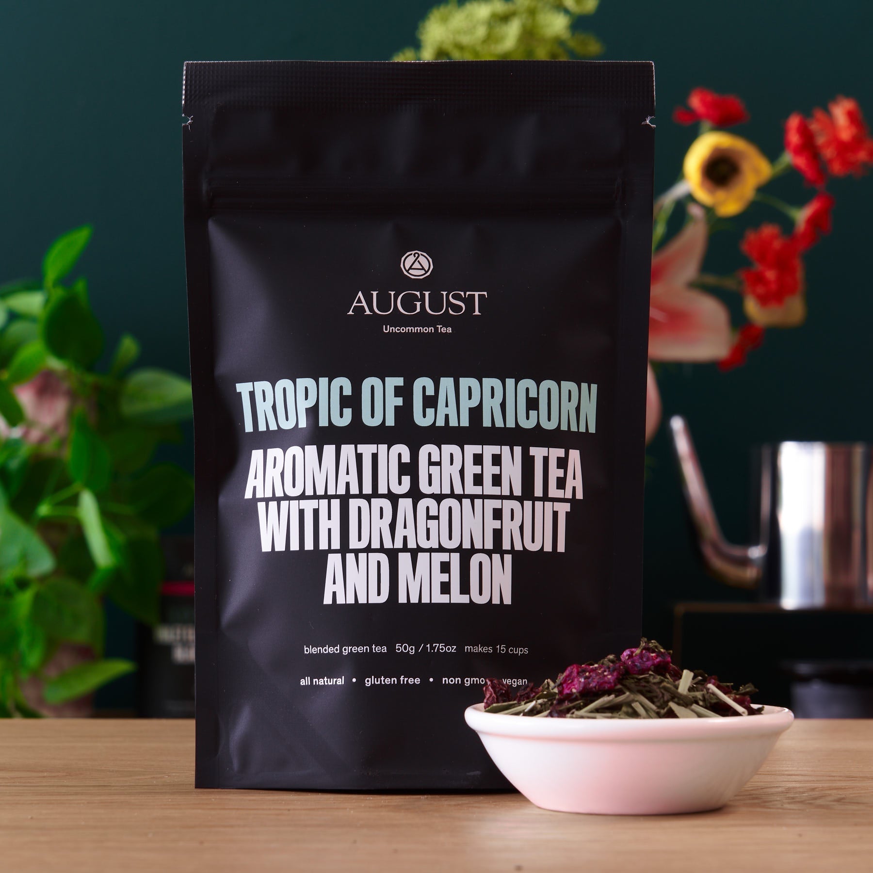 August Uncommon Tea Tropic of Capricorn Dragonfruit Melon Green Tea in a 15-cup bag, vibrant green tea leaves with fruit-infused flavor