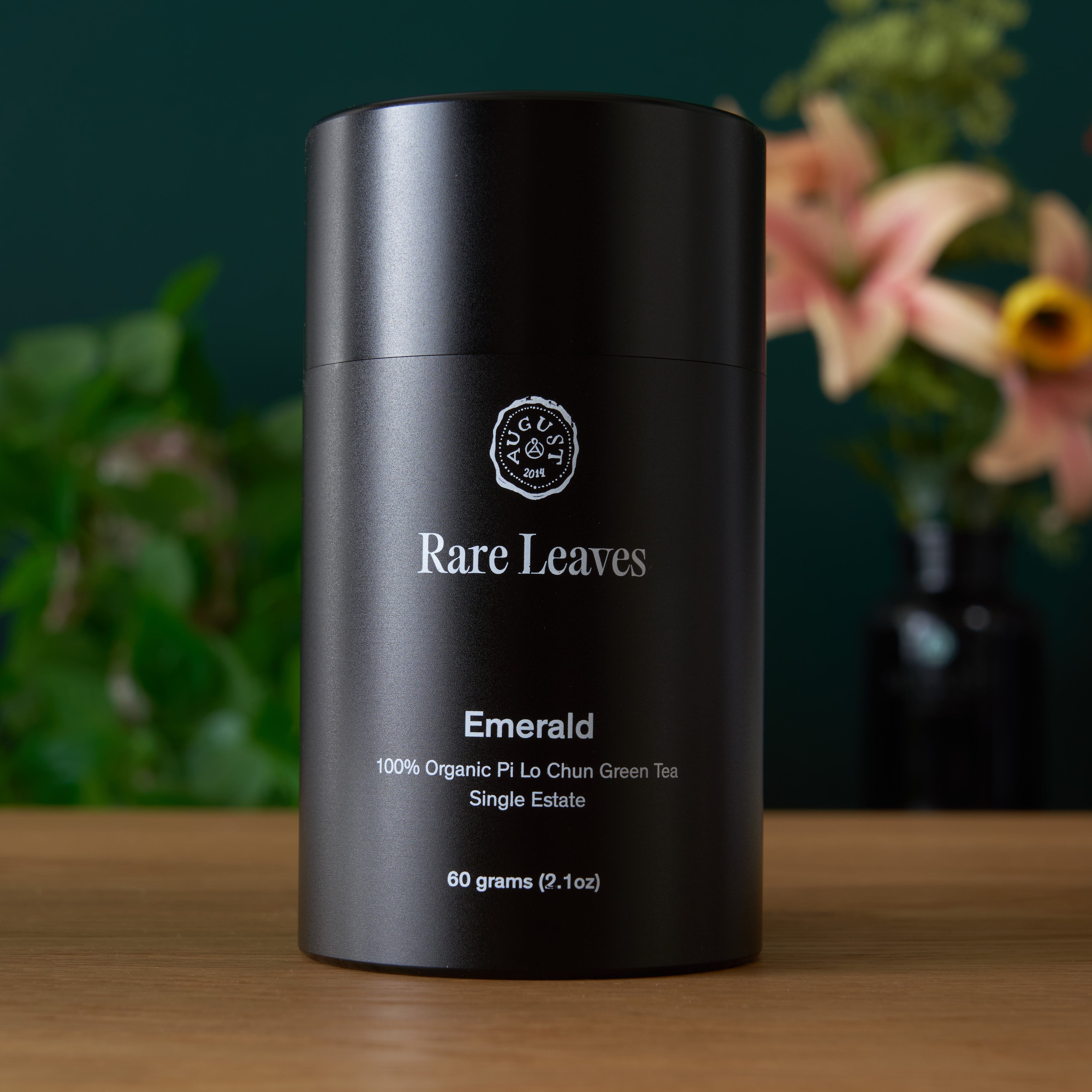 August Uncommon Tea Rare Leaves Emerald Pi Lo Chun Green Tea in a 60g tin, showcasing fresh green tea leaves from single estate harvest.