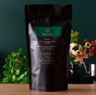August Uncommon Tea Rare Leaves Emerald Pi Lo Chun green tea in a 60g tin, showcasing fresh, rolled green tea leaves.