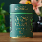 Box of August Uncommon Tea Essentials Bright Green Green Tea with 15 tea bags, featuring vibrant green packaging and tea bags inside.