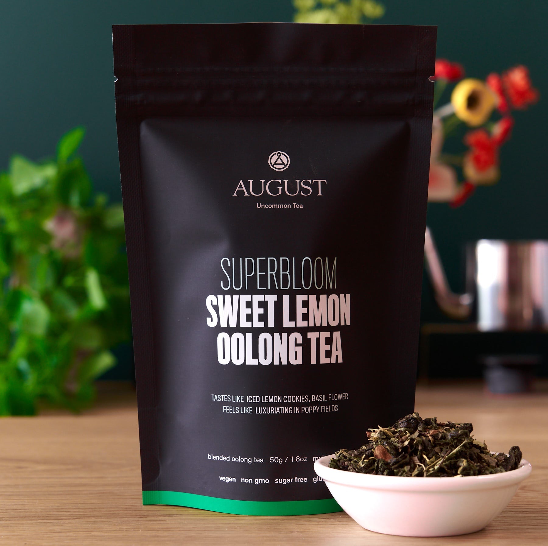 Sweet Lemon Oolong Green Tea by August Uncommon Tea in a 15-cup bag, showcasing fresh lemon and green tea leaves.
