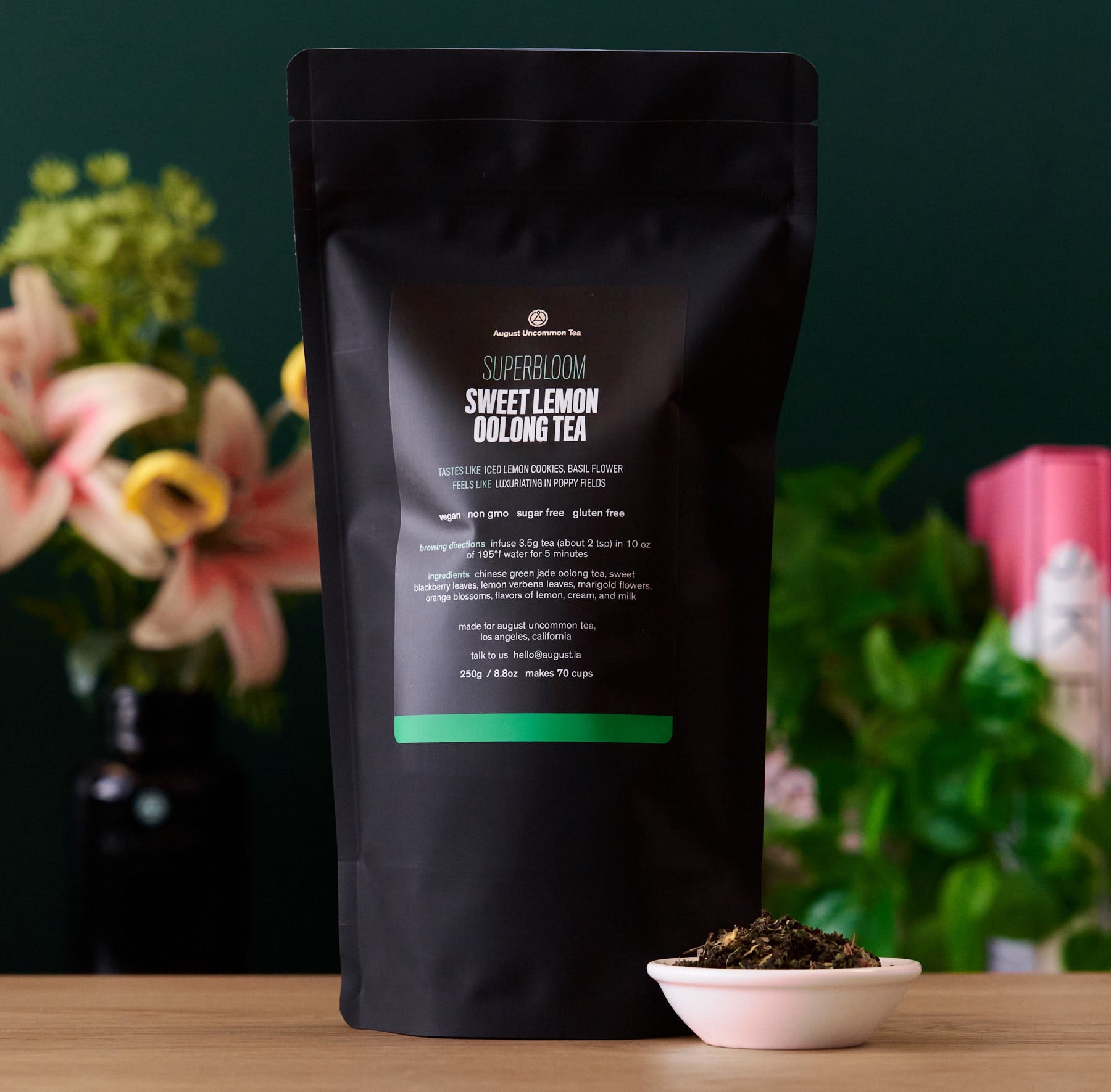 August Uncommon Tea Superbloom Sweet Lemon Oolong Green Tea in a 15-cup bag, showcasing fresh lemon and green oolong tea leaves.