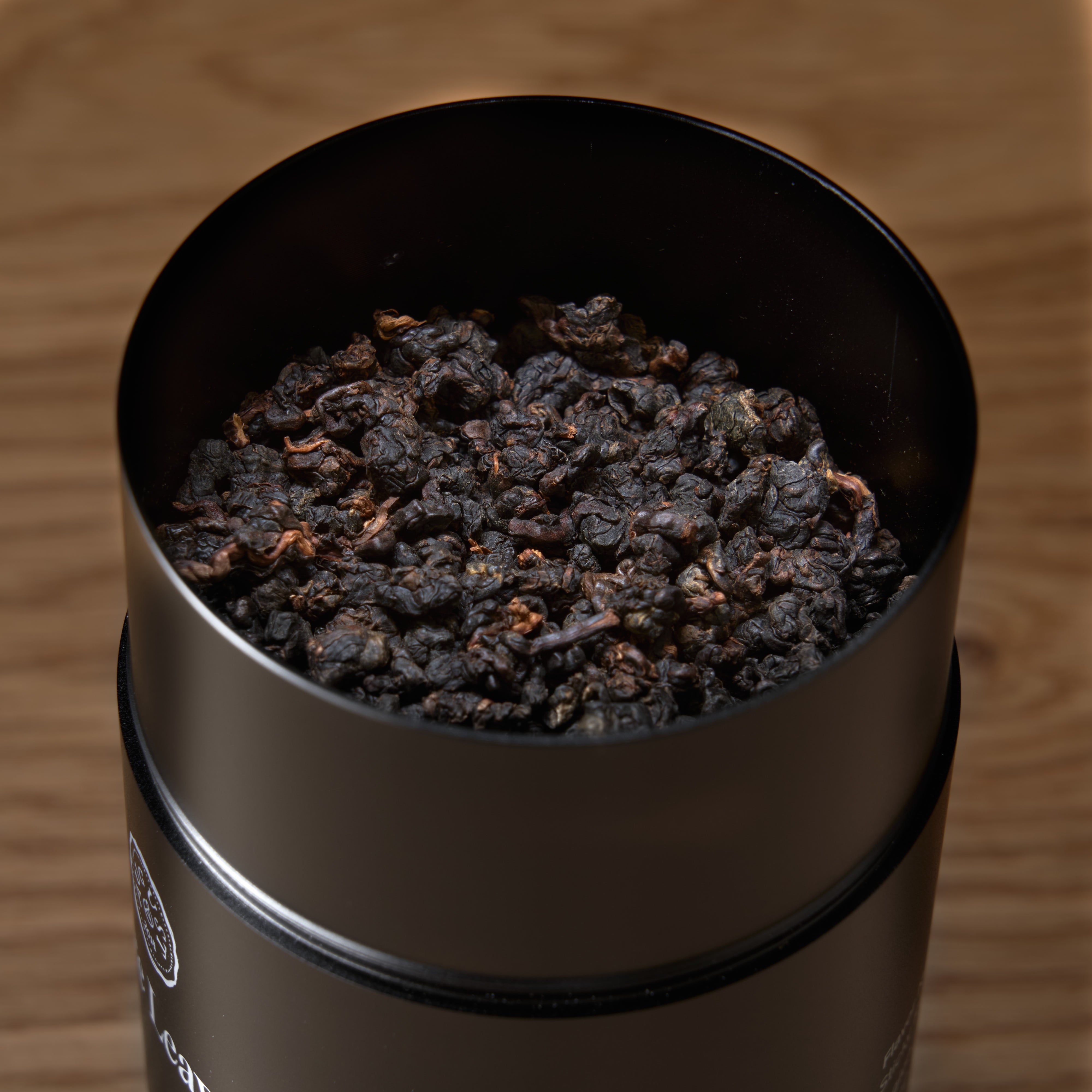 Black Pearl Oolong Tea tin by August Uncommon Tea, single estate Taiwanese dark roasted oolong beverage with loose tea leaves.