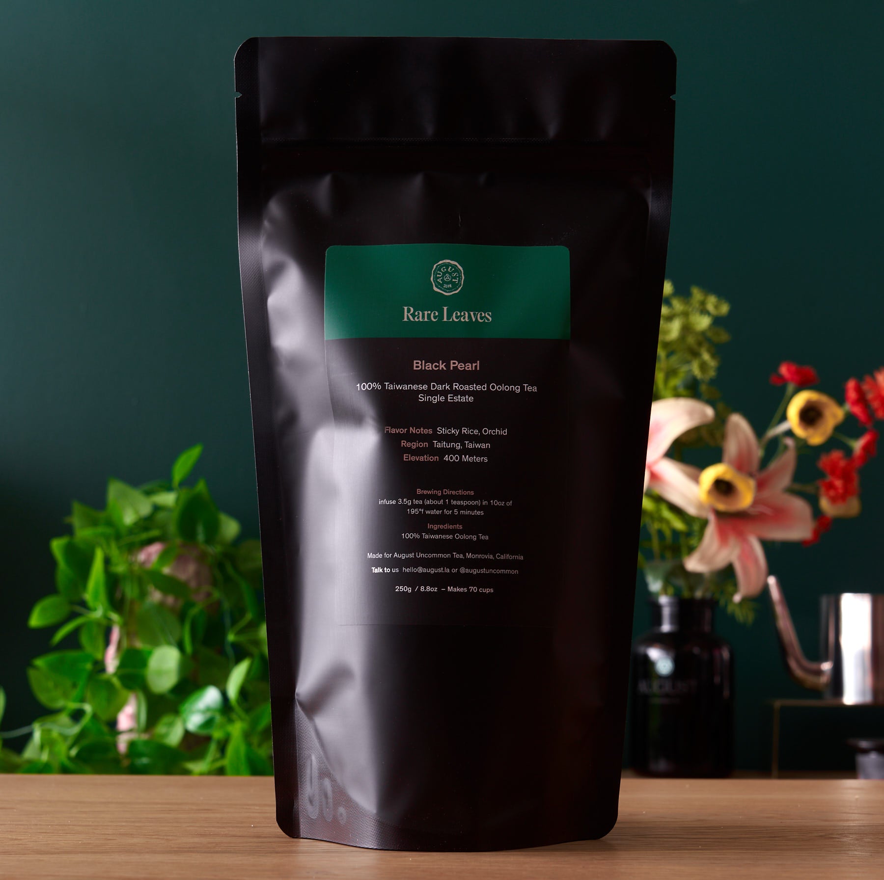 Black Pearl Taiwanese Dark Roasted Oolong Tea in a 150g tin by August Uncommon Tea, featuring dark roasted oolong leaves.