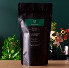 Black Pearl Taiwanese Dark Roasted Oolong Tea in a 150g tin by August Uncommon Tea, featuring dark roasted oolong leaves.
