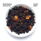 August Uncommon Tea Avalon Burnt Apple Oolong Tea in a 23 oz tin, showcasing rich tea leaves in a vibrant package.