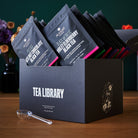 August Uncommon Tea Library Deluxe 30 Tea Sampler with assorted tea bags, showcasing a variety of teas for tasting.