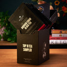 Assorted tea sachets from August Uncommon Tea's Top 10 Sampler featuring ten trending teas in a colorful box.