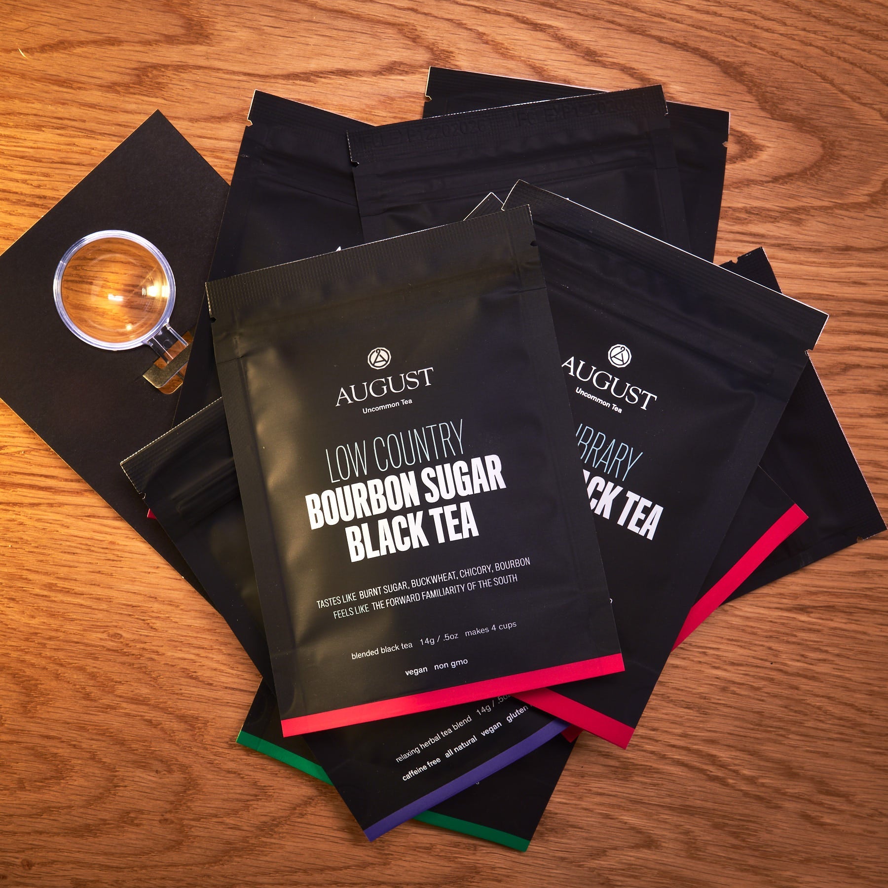 Assortment of ten trending teas in colorful tea bags from August Uncommon Tea, arranged in a display for tasting sampler.