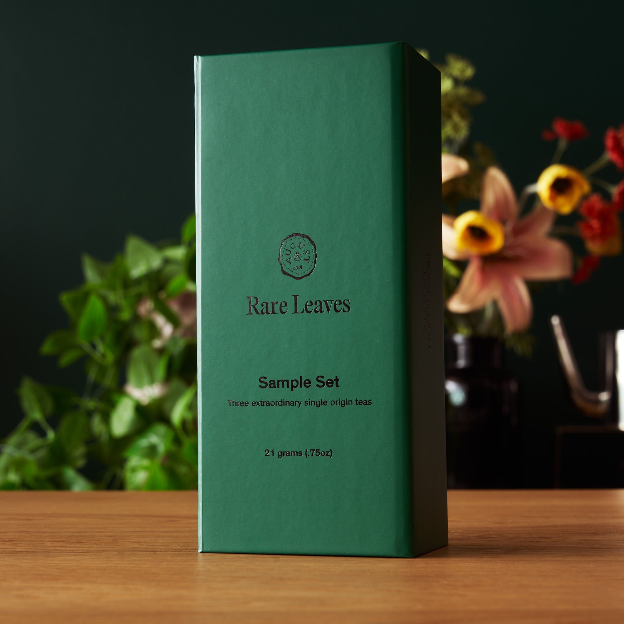 Assorted rare leaves single origin tea mini tin sampler by August Uncommon Tea, featuring a compact tin with tea leaves and branding.