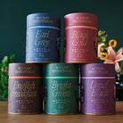 Assorted August Uncommon Tea All The Essentials tea bag bundle with various tea flavors in individual sachets.