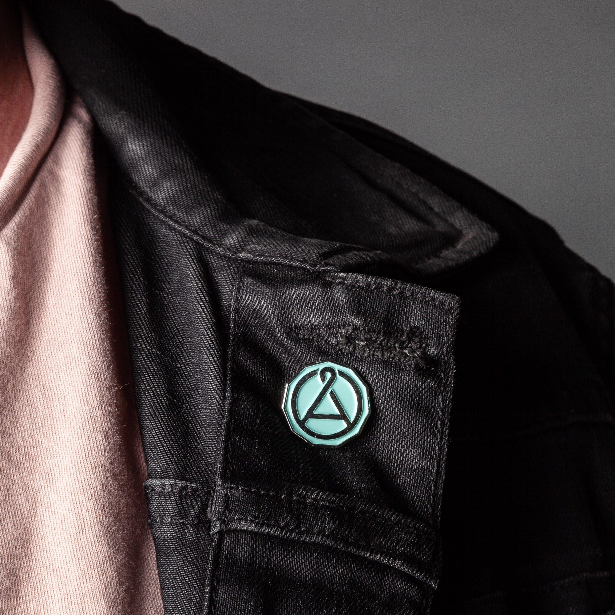 August Seal Enamel Pin from August Uncommon Tea swag collection, featuring a detailed seal design on a metal pin.