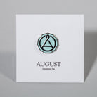 August Seal enamel pin from August Uncommon Tea swag collection, featuring a detailed seal design on a metal pin.