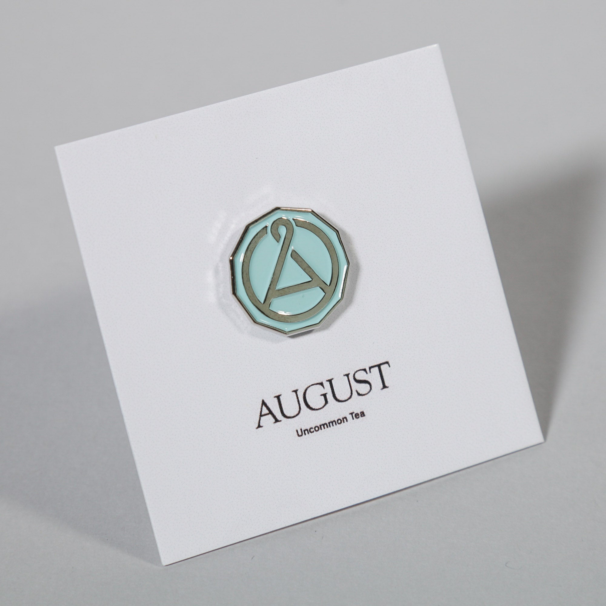 August Seal Enamel Pin from August Uncommon Tea swag collection, featuring a detailed, colorful seal design.