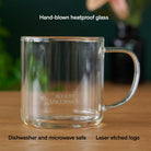Clear glass mug from August Uncommon Tea, elegant teaware for hot beverages, showcasing a sleek, transparent design with a comfortable handle.