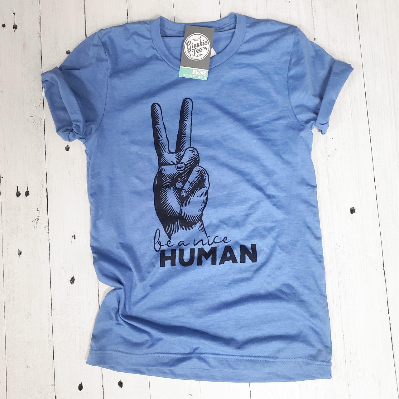 Unisex graphic tee from The Graphic Tee featuring "Be A Nice Human" message on a casual short-sleeve shirt.