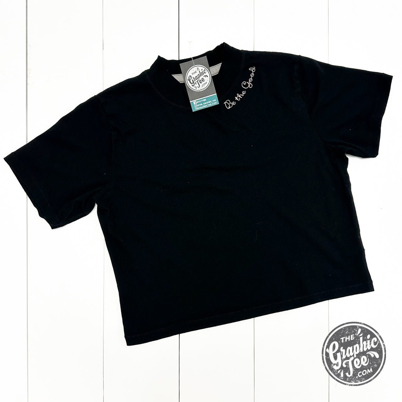 Be The Good embroidered waist-length crop tee from The Graphic Tee, featuring a casual SS graphic design and embroidered detail.