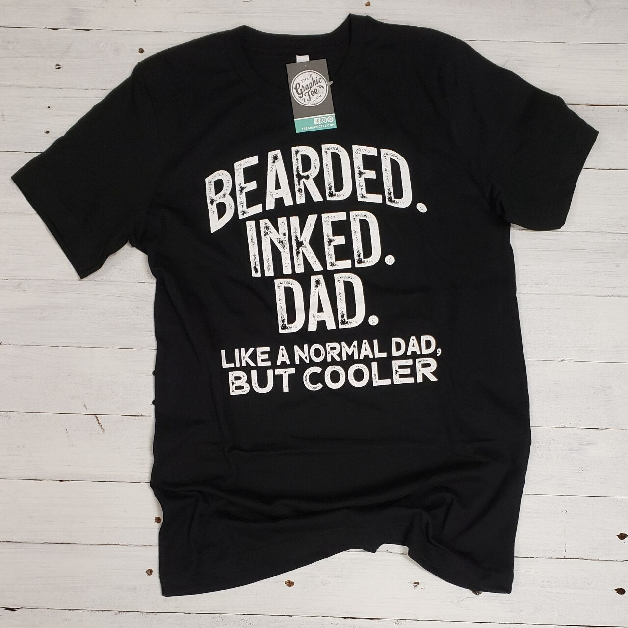 Bearded Inked Dad SS Graphic Tee by The Graphic Tee featuring a bearded man with tattoos on a casual t-shirt.