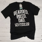 Bearded Inked Dad SS Graphic Tee by The Graphic Tee featuring a bearded man with tattoos on a casual t-shirt.