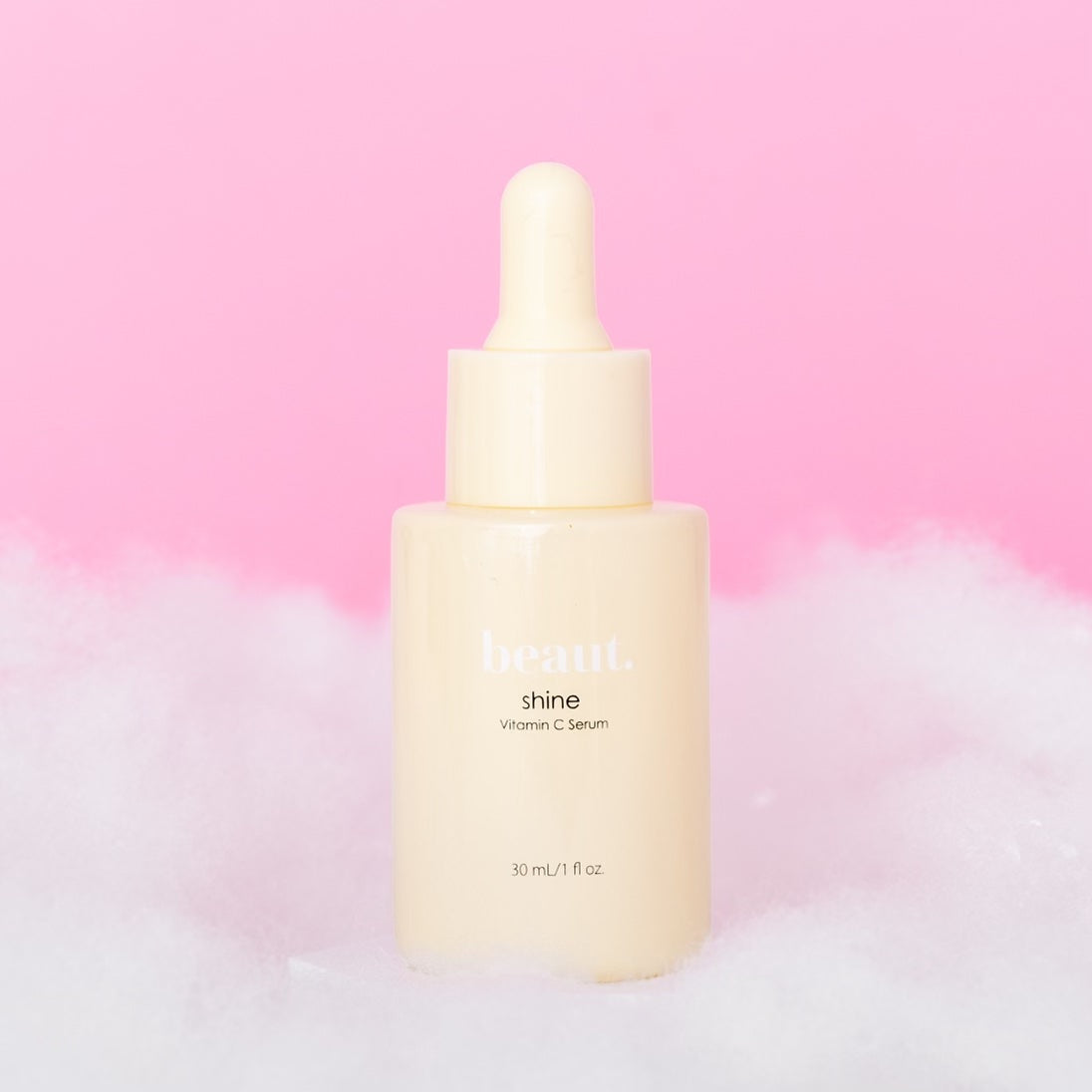 Two bottles of Beaut.BeautyCo. Shine Vitamin C Serum with clear dropper caps, showcasing the bright orange serum inside.