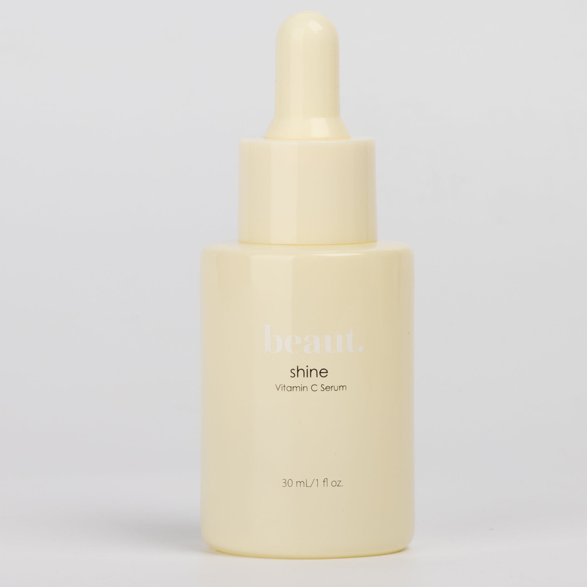 Two bottles of Beaut.BeautyCo Shine Vitamin C Serum displayed side by side in clear glass bottles with dropper caps.