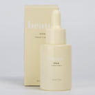 Two bottles of beaut.beautyco. Shine Vitamin C Serum with dropper applicators, shown with clear glass bottles and orange label details.