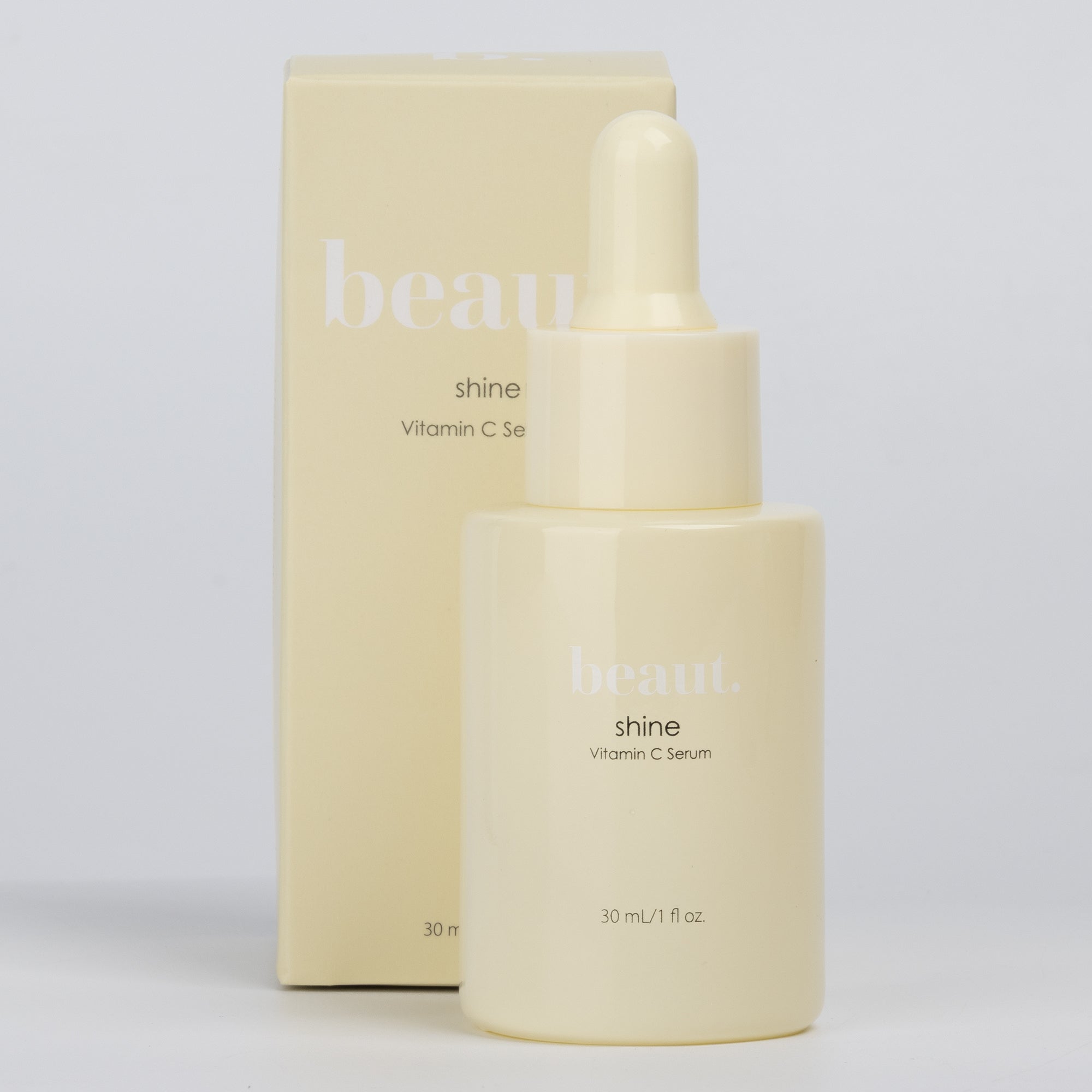 Two bottles of beaut.beautyco. Shine Vitamin C Serum with dropper applicators, shown with clear glass bottles and orange label details.