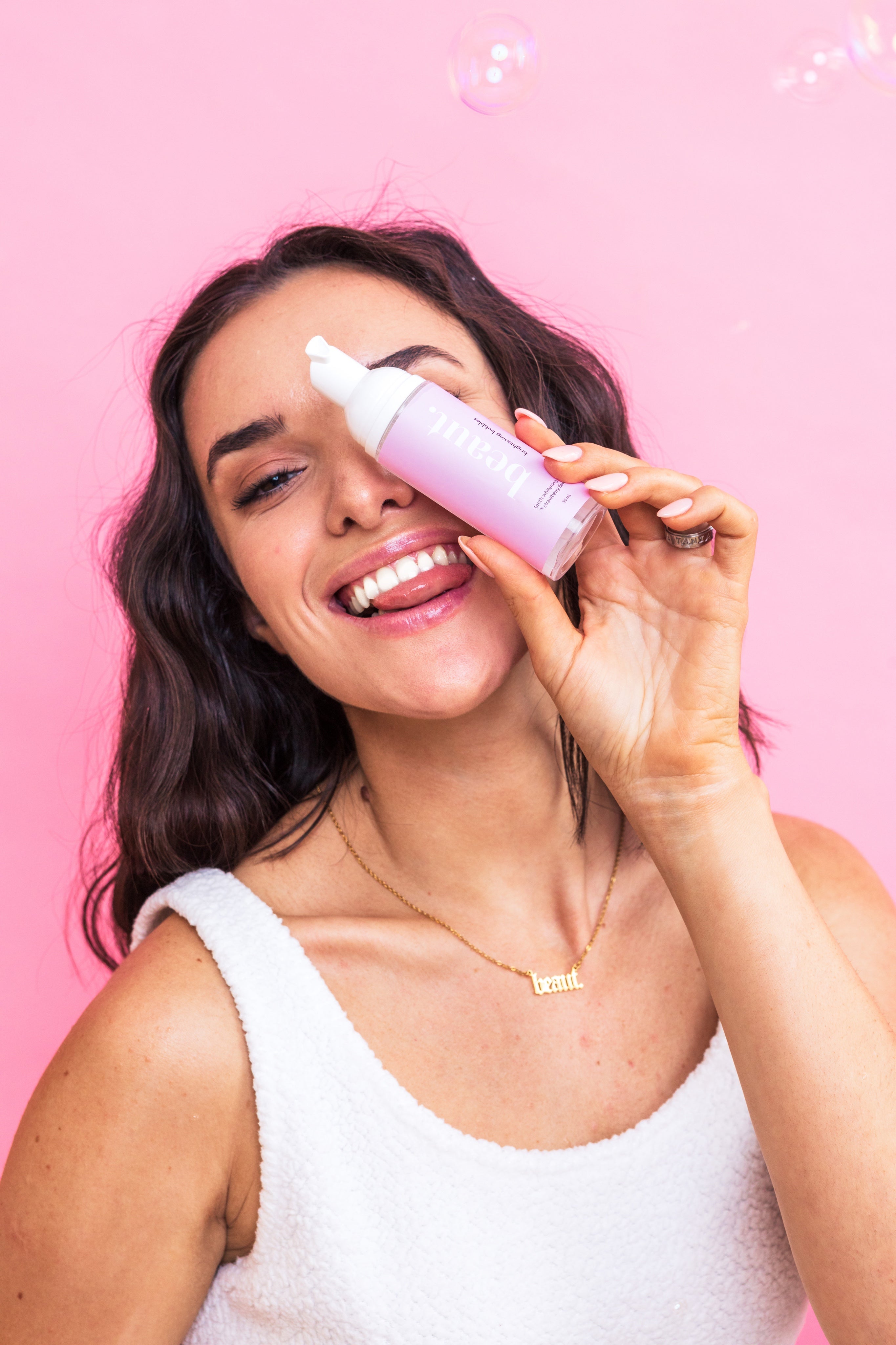 Brightening strawberry bubbles by beaut.beautyco. with vibrant pink bubbles and a clear container, emphasizing fresh, fruity skincare.
