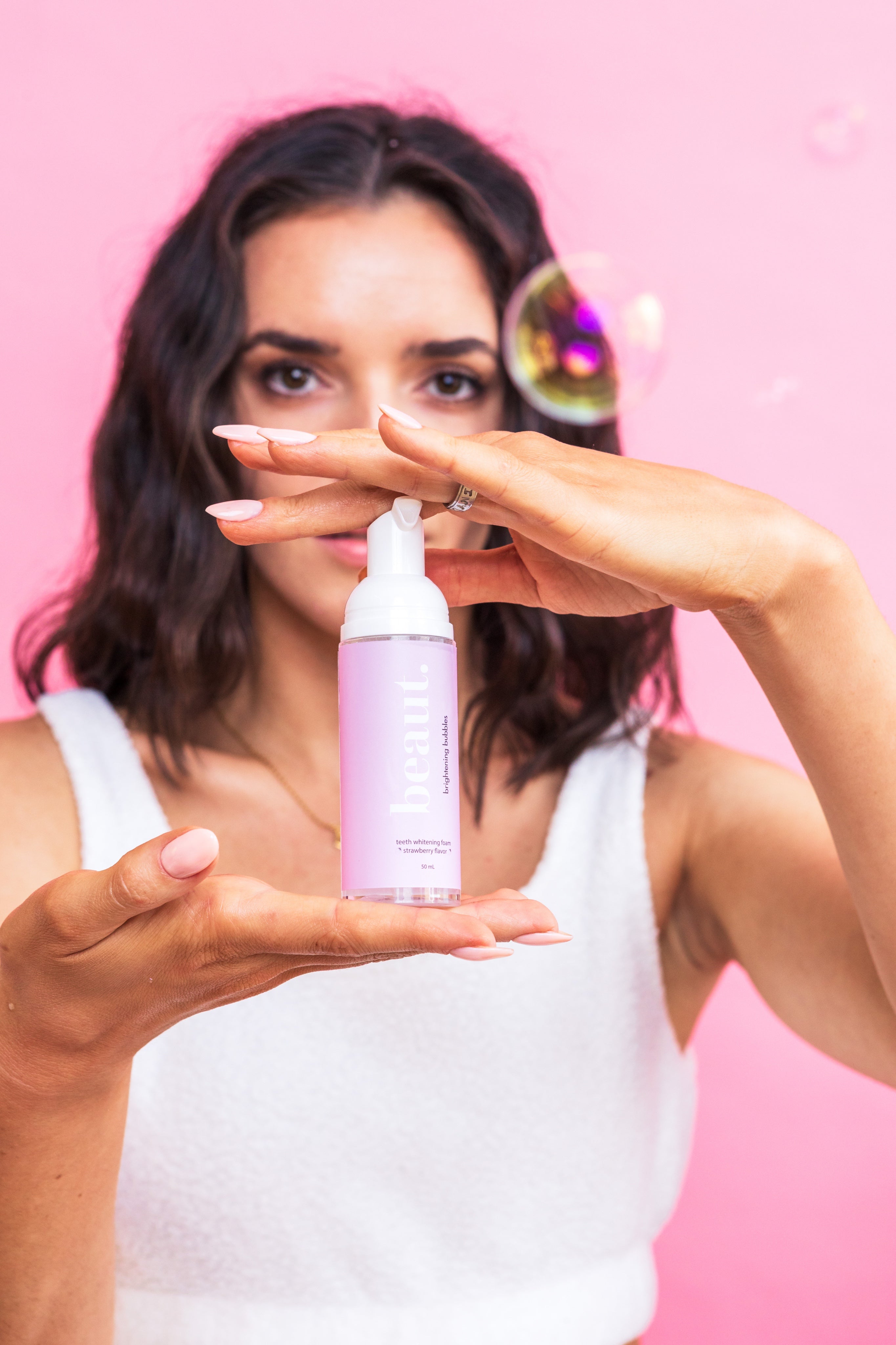 Beauty.beautyco. Strawberry Brightening Bubbles in a clear jar with pink and white bubbles, showcasing the skincare product.