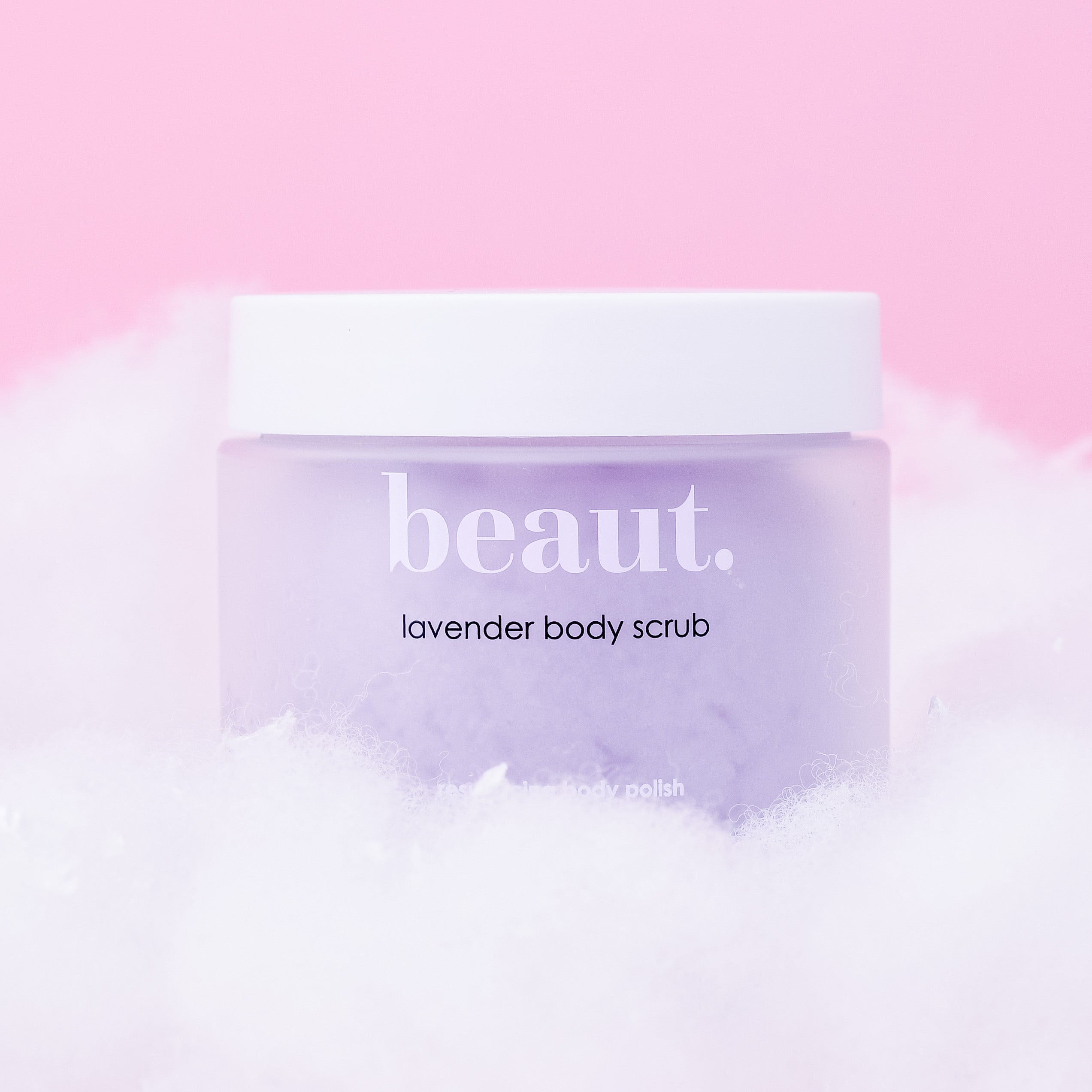 Lavender body scrub by beaut.beautyco, showing a jar of exfoliating scrub with lavender flowers and creamy texture.