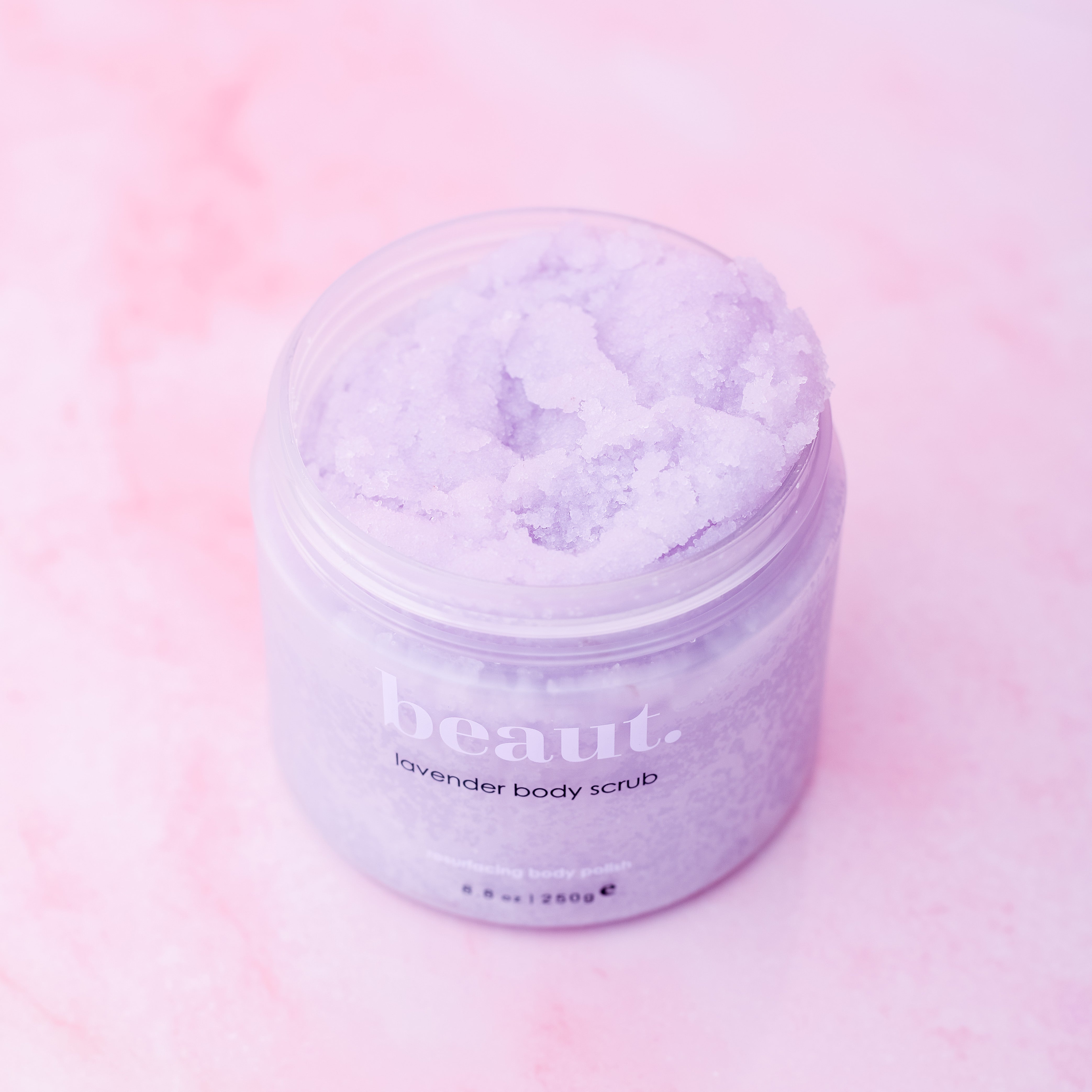 Lavender body scrub by beaut.beautyco featuring a textured jar with lavender-infused exfoliating scrub inside.