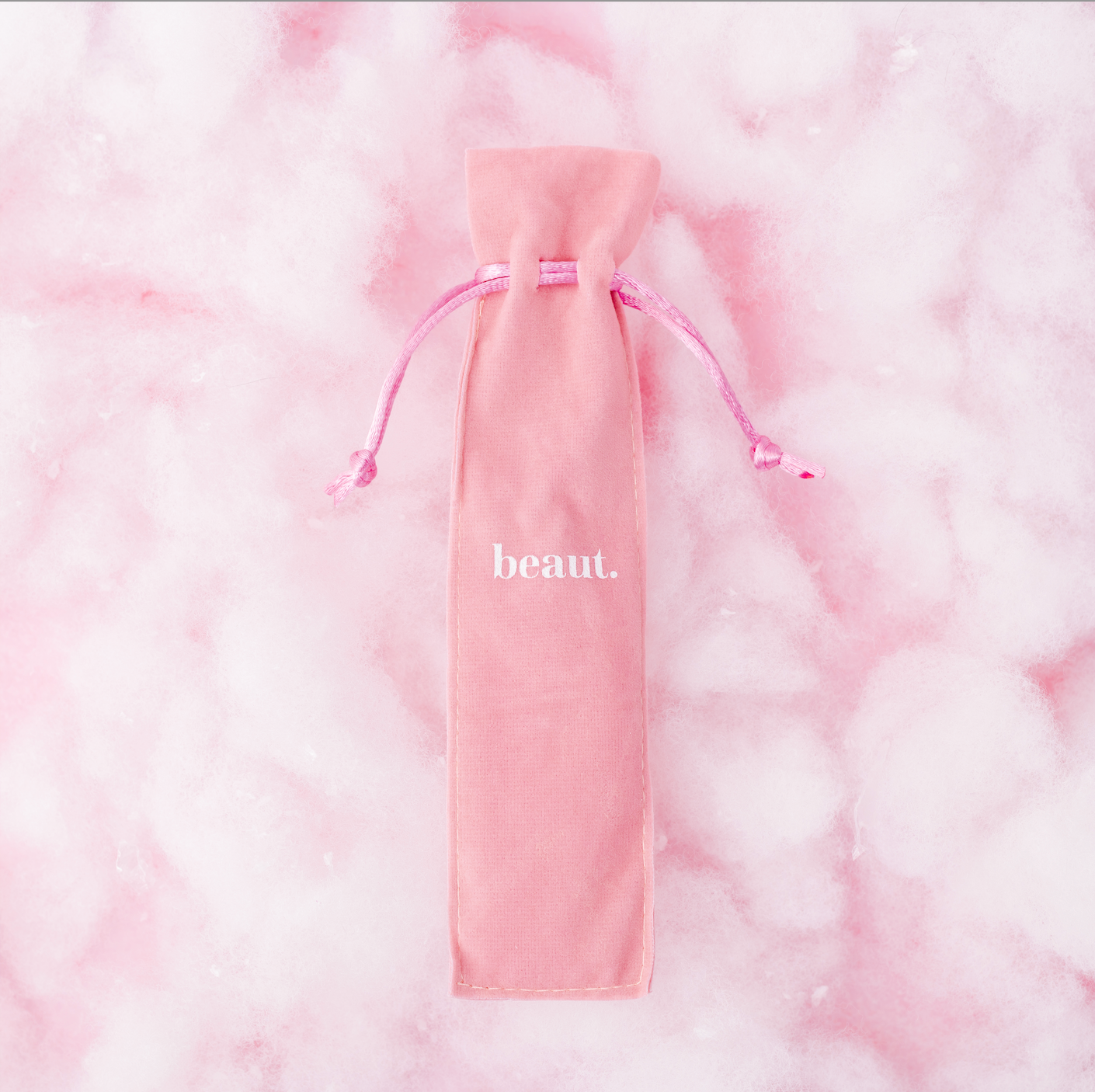Pink tongue scraper from beaut.beautyco with a smooth, ergonomic design for oral hygiene and freshening breath.