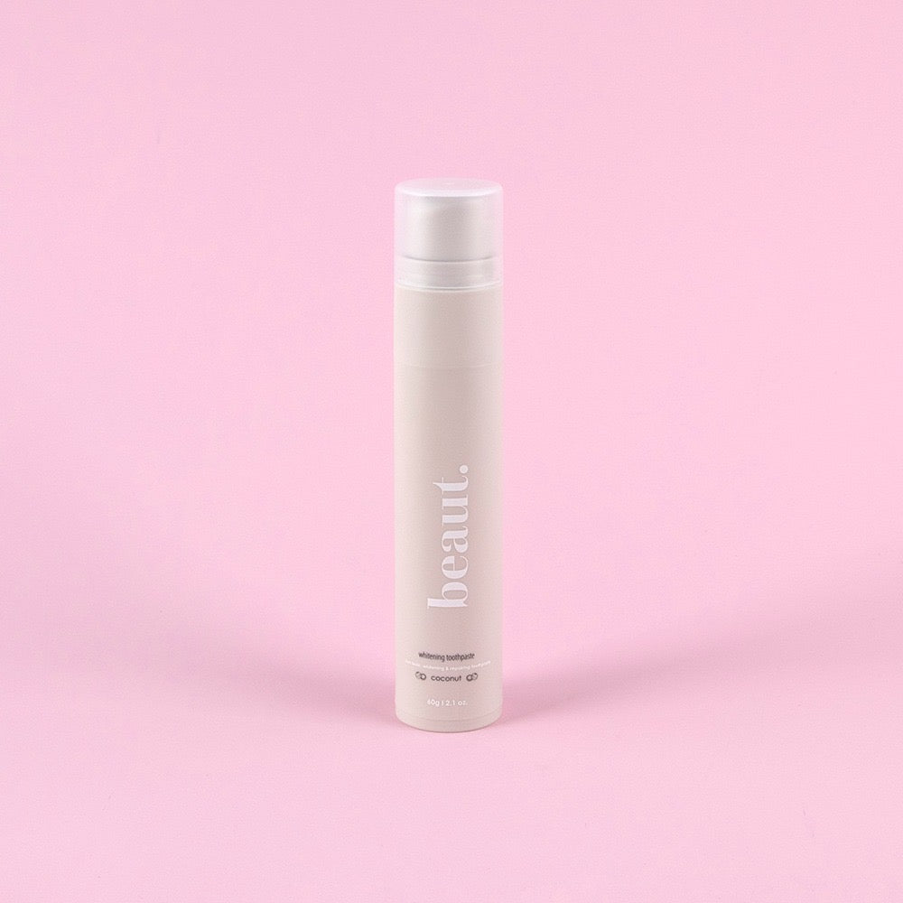Beaut.beautyco coconut whitening toothpaste tube with white and green packaging, featuring a coconut illustration.
