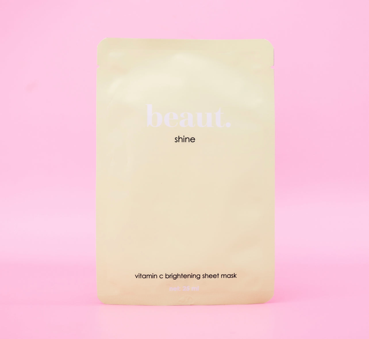 Beaut.beautyco. Shine sheet mask lying flat, showing the sleek packaging and bright design for glowing skin.