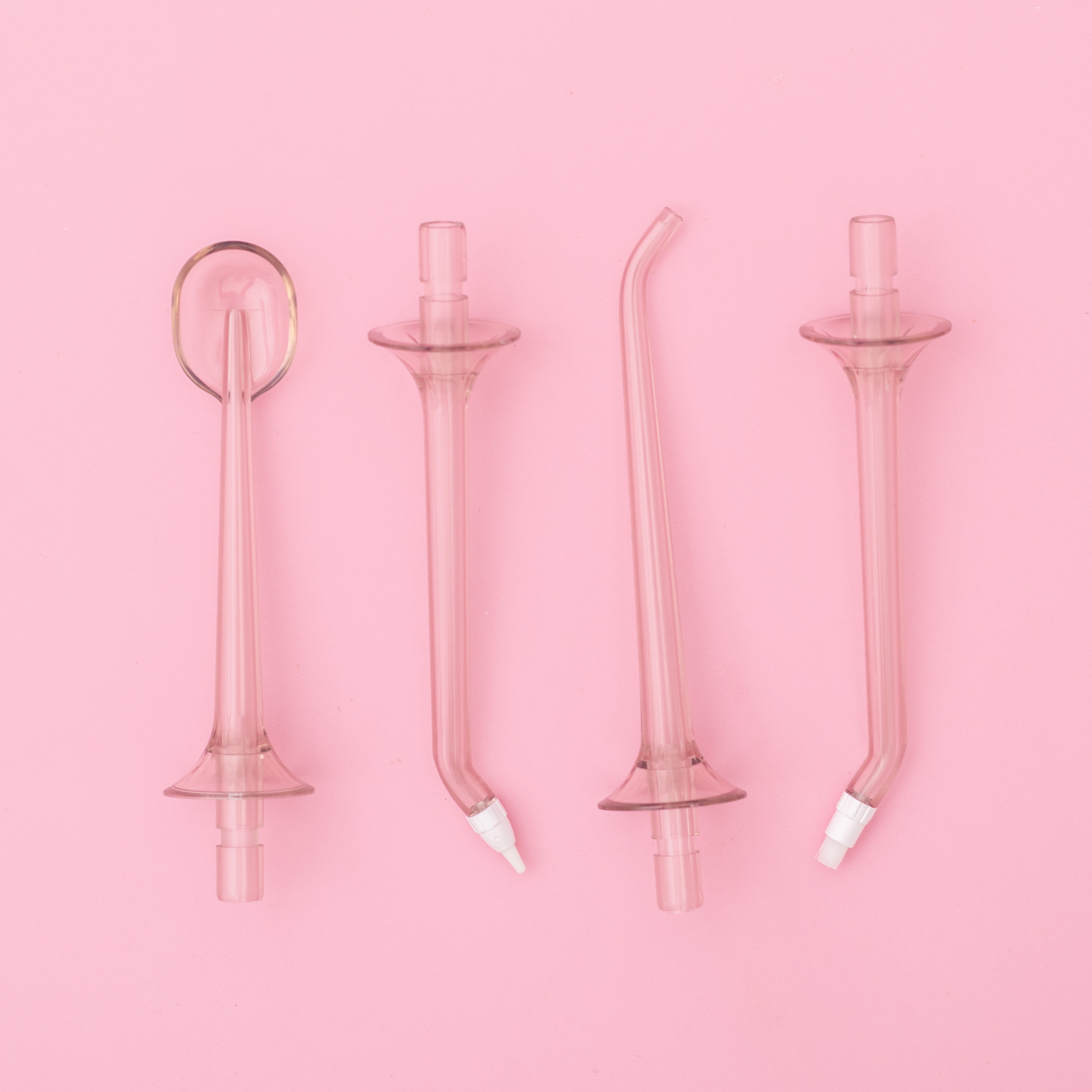 White H2O Hydroflossé by beaut.beautyco. featuring a sleek, modern water flossing device with a compact design.
