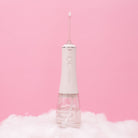White H2O Hydroflossé water flosser by beaut.beautyco. with sleek design and water reservoir for oral hygiene.