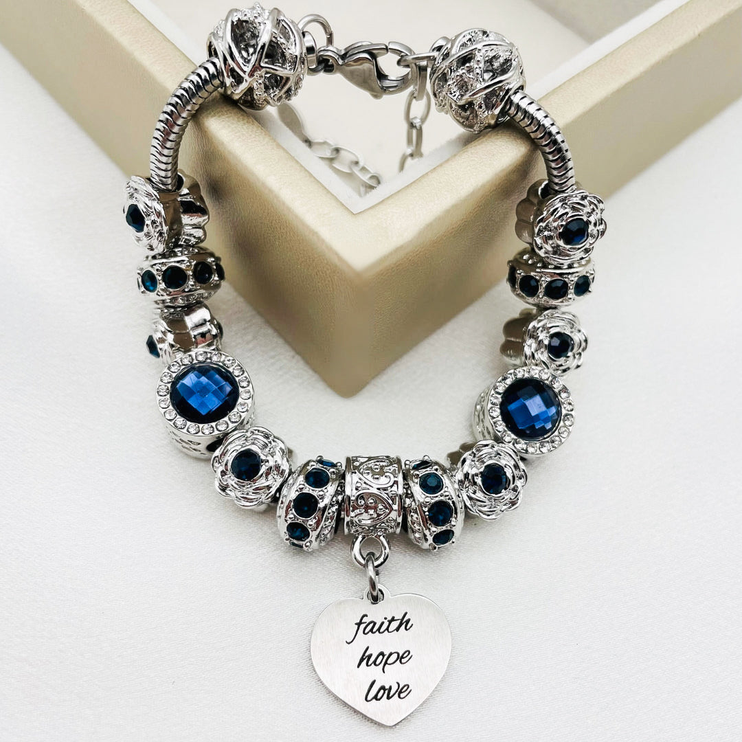 Bella's Yard Faith Hope Love Bracelet with engraved charms on a delicate chain, showcasing inspirational jewelry design.