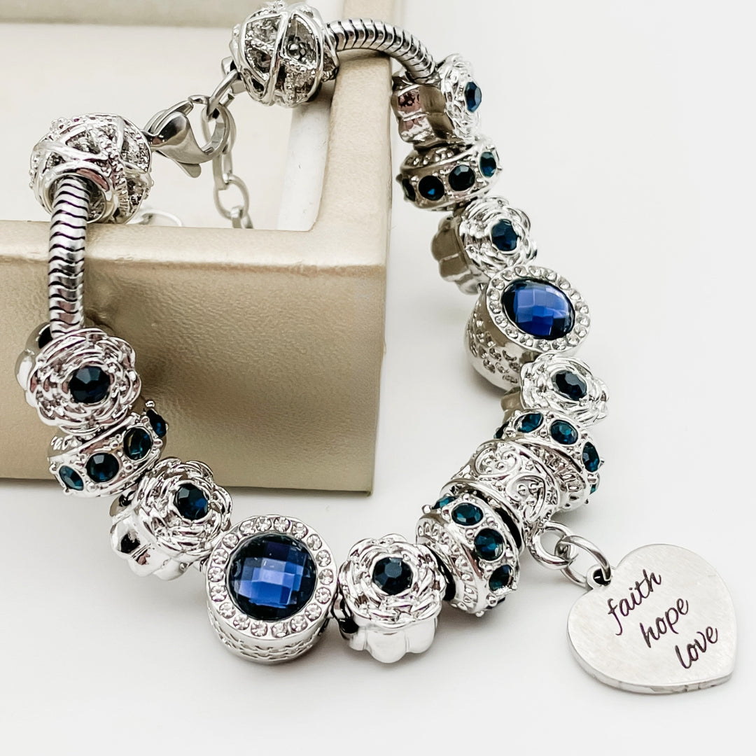 Bella's Yard Faith Hope Love bracelet featuring engraved charms on a delicate chain, symbolizing faith, hope, and love.