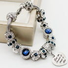 Close-up of Bella's Yard Faith Hope Love bracelet featuring engraved metal charms on a delicate chain.