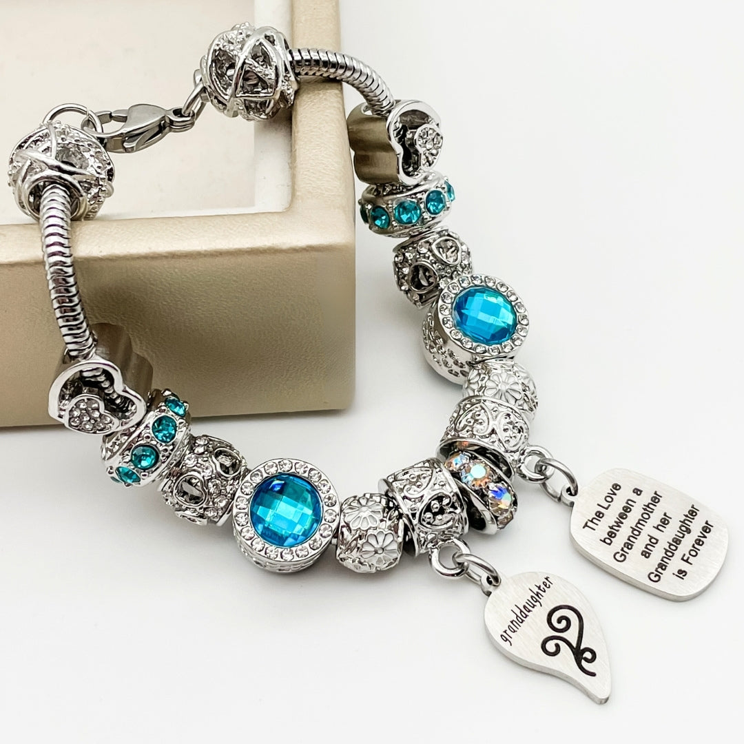 Silver grandmother and granddaughter unending love bracelets from Bella's Yard with intertwined heart designs.