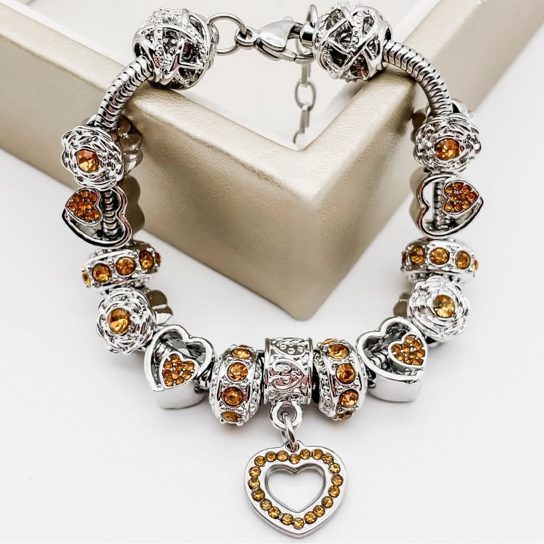 Colorful birthstone bracelets by Bella's Yard featuring gemstone beads and adjustable clasps on a soft background.