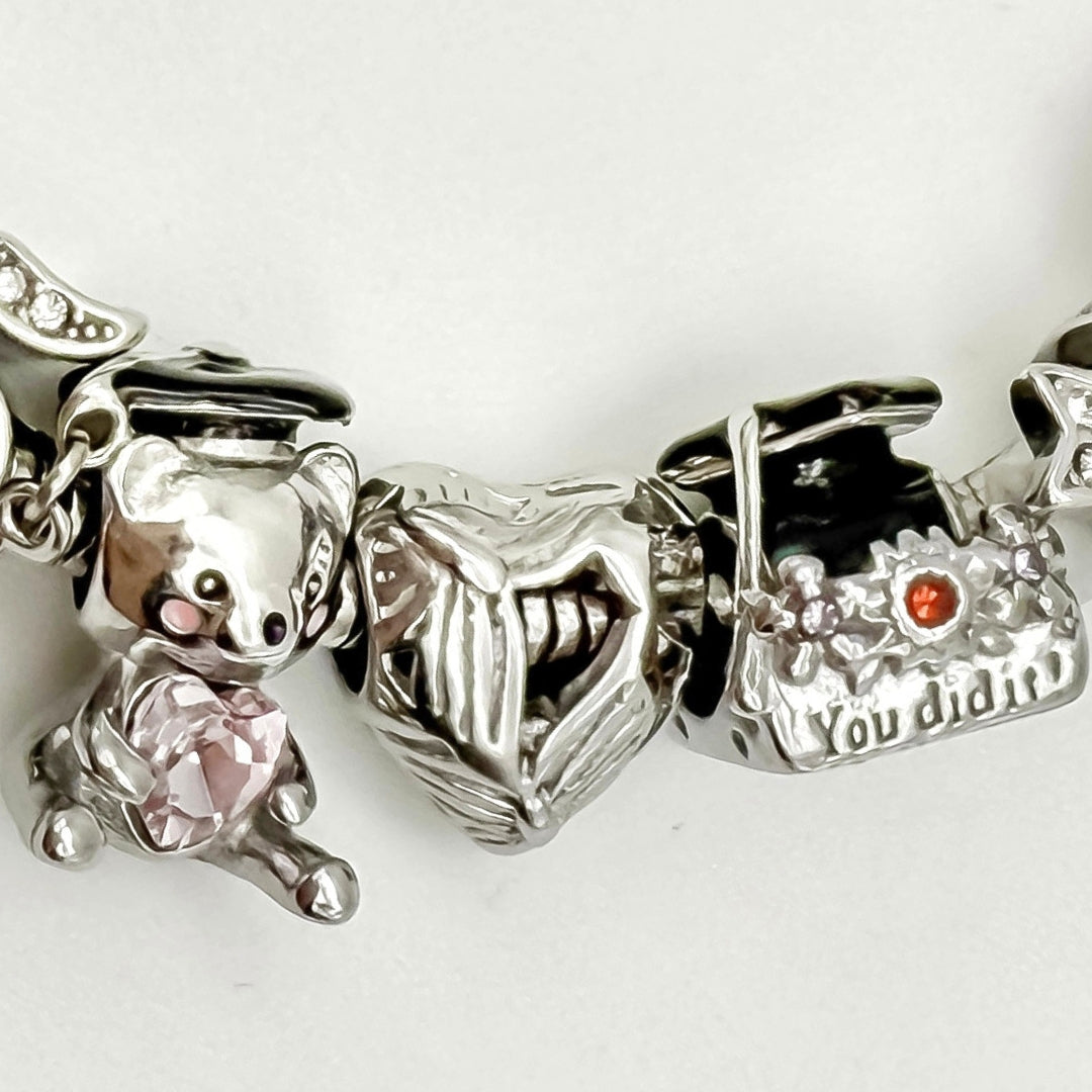 You Did It Graduation Bracelet by Bella's Yard featuring a silver bracelet with a "You Did It" charm for celebrating graduation success.