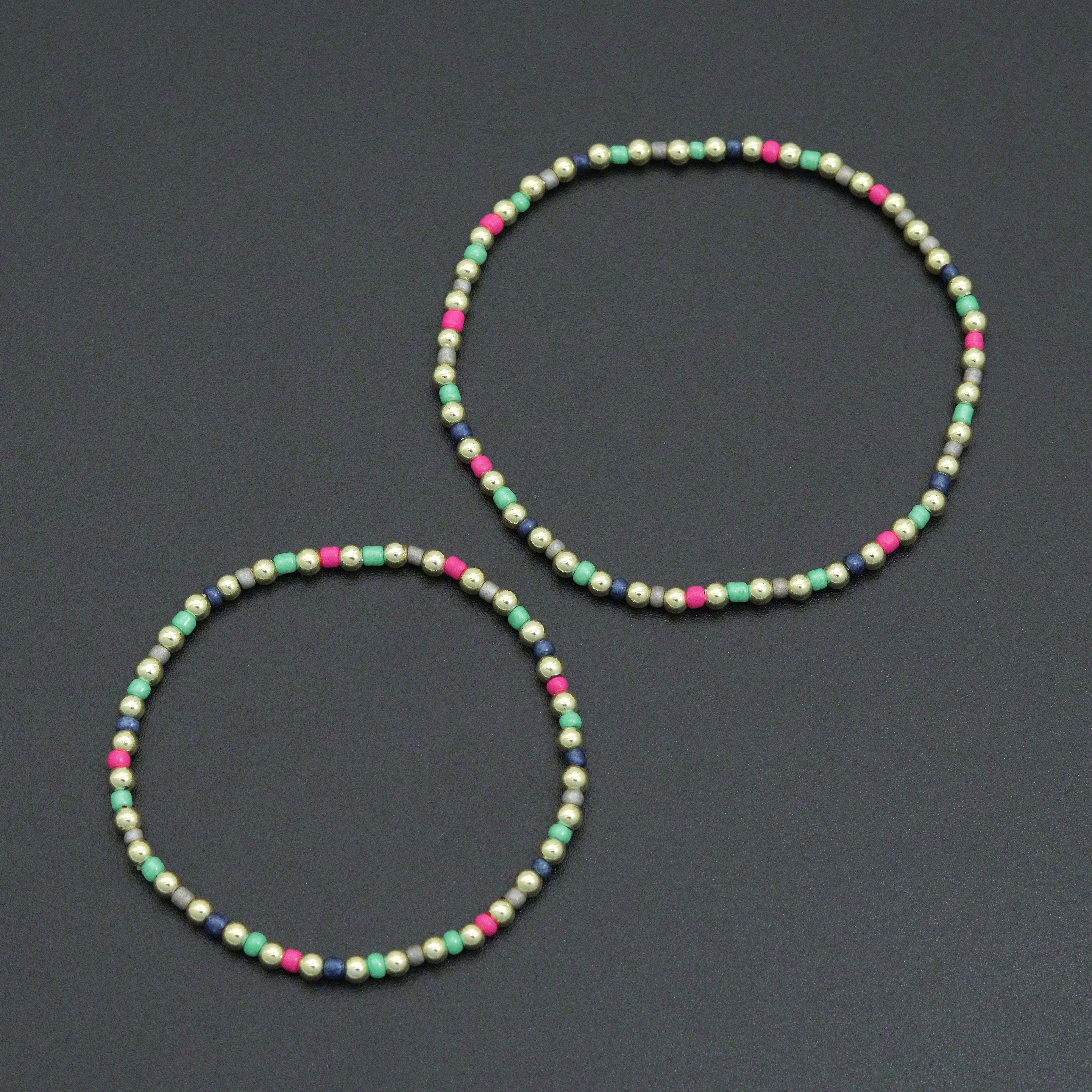 7-inch Rainbow Hematite Stretchy Bracelet by Bestbeads&Beyond featuring colorful rainbow hematite beads on an elastic band.