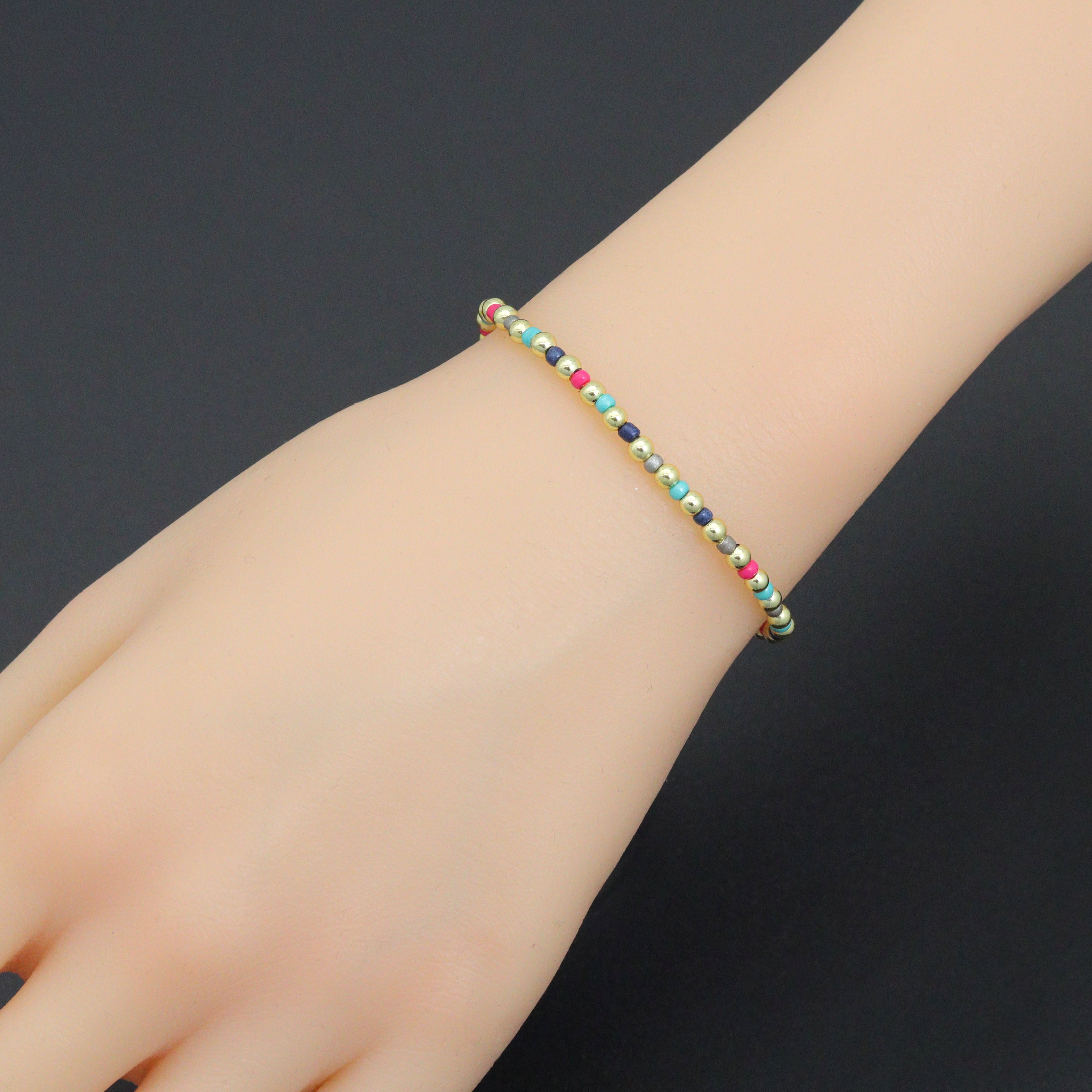 7-inch rainbow hematite stretchy bracelet by Bestbeads&Beyond featuring colorful, smooth hematite beads on a flexible band.