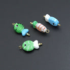 Red and green striped glass fish charm pendant from Bestbeads&Beyond, featuring a detailed fish charm for jewelry making.